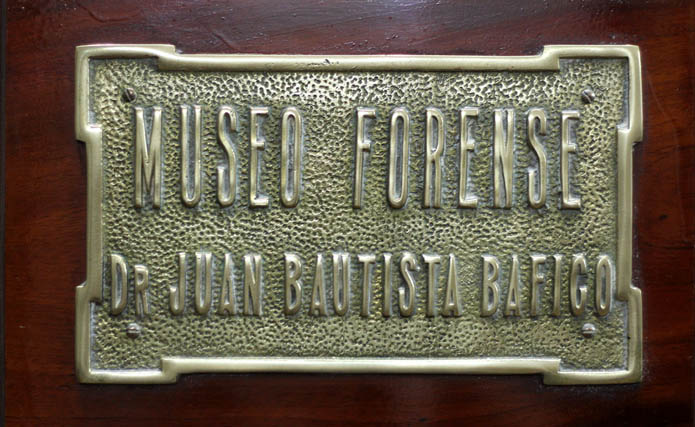 Placa identificatoria del Museo Forense Dr. Juan Bautista Bafico sobre una base de madera.